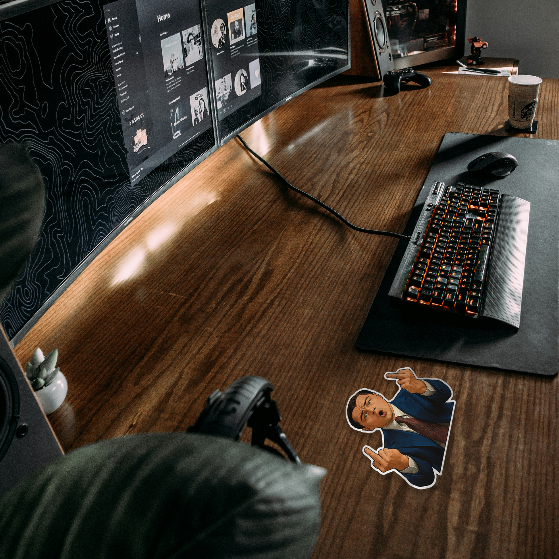 Wooden desk with computer setup including dual monitors, keyboard, and mouse. Wolf of Wall Street movie Sticker.