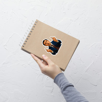 Notebook with a sticker of Wolf of Wall Street on a white textured surface